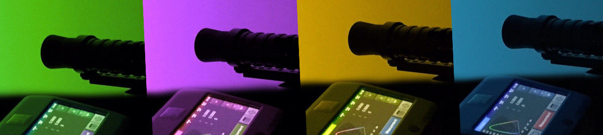 Two calibration probes measuring color patches off a screen.